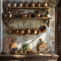 an old kitchen with pots and pans hanging on the wall, next to a wooden table