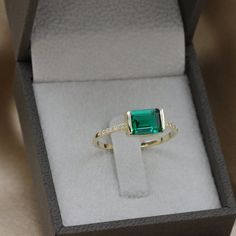 Handmade by an inspired jewelry artist team with decades of experience in the craft of jewelry making.Each gemstone, each diamond is carefully picked.Using only the finest raw materials and the highest industry standard in manufacturing, design and finish.A beautiful vintage inspired piece handmade just for you.Horizontally set Green radiant cut Emerald and Diamonds ring in a perfectly proportioned fine piece of jewelry.Beautifully finished this emerald ring will bring out the best in you and gi Emerald Ring Modern, Princess Cut Emerald Ring, Fine Jewelry Green Radiant Cut Diamond Ring, Green Radiant Cut Diamond Ring Fine Jewelry, Green Radiant Cut Diamond Ring, Modern Green Emerald Ring With Accent Stones, Fine Jewelry Green Diamond Ring With Square Cut, Modern Emerald Rings With Baguette Cut, Green Square Cut Diamond Ring Fine Jewelry