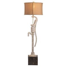 a lamp with a monkey on it and a light shade hanging from the top of it