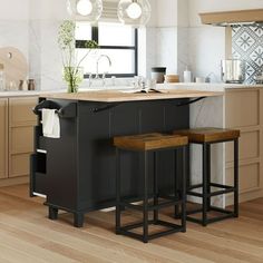 a kitchen island with stools in front of it