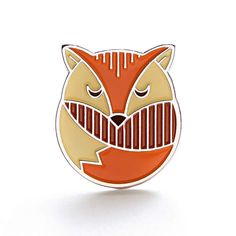 an orange and white enamel fox head pin