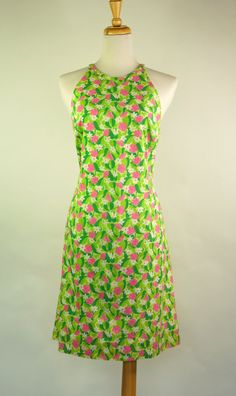 Vintage Lilly Pulitzer sleeveless dress. This adorable dress features a fun print that consists of lime green lizards hidden amongst pink and white flowers and green leaves. This cold-shouldered dress has self trim at the neckline, is fully lined and closes down the back with a 22 inch invisible zipper. Size 12. Please see measurements.   -Measurements:    -Bust: 38 inches    -Waist: 34 inches    - Hips: 43 inches    -Length: 36 inches Green Lined Sleeveless Summer Dress, Green Lined Sleeveless Dress For Summer, Green Sleeveless Lined Sundress, Green Printed Sundress, Green Summer Dress Lined, Green Lined Summer Dress, Fitted Sleeveless Lime Green Dress, Green Fitted Halter Neck Sundress, Fitted Green Halter Neck Sundress