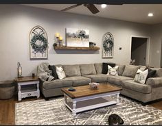 a living room filled with furniture and a cat laying on top of a rug in front of the couch