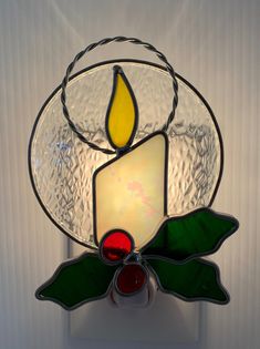 a stained glass candle holder on a wall