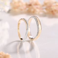 two wedding rings sitting on top of each other