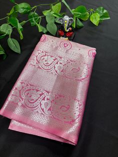 This exquisite Semi Kanchipuram Saree is a stunning addition to any wardrobe. The premium quality soft material is comfortable against the skin and drapes beautifully, making it perfect for special occasions. The vibrant pink color adds a pop of brightness to the traditional design, while the intricate gold border detailing adds a touch of elegance. Made with care and attention to detail, this saree is a must-have for any fashion-forward individual looking to make a statement at a wedding, party, or cultural event.Upgrade your saree collection with this timeless piece that effortlessly combines classic style with modern sophistication. Elegant Pink Saree For Navratri, Elegant Pink Traditional Wear With Pallu, Elegant Pink Tissue Silk Traditional Wear, Elegant Pink Art Silk Traditional Wear, Pink Tissue Silk Saree For Festivals, Pink Tissue Silk Saree For Celebration, Elegant Pink Dupatta For Navratri, Elegant Pink Blouse Piece With Zari Weaving, Elegant Pink Traditional Wear For Navratri