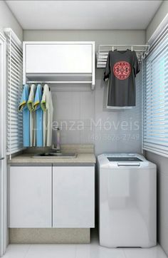 a small laundry room with clothes hanging on the rack