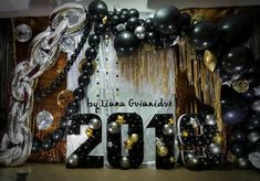 balloons and streamers decorate the backdrop for a new year's eve celebration