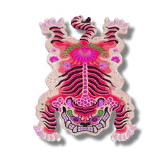 a pink and black tiger with flowers on it's head, sitting in front of a white background