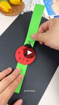 someone is making a paper ladybug craft