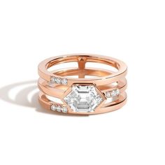 We uphold our brand promise of honoring personal journeys by inviting our customers to celebrate one of life’s biggest milestones with the 2018 Diamond Foundry Deco Capsule. The bridal collection draws inspiration from the decadence of the roaring 20’s, made anew by fashioning the deco silhouettes into minimal designs better fit for the 2020s. Three band ring with nine scoop-set diamonds surround a semi-bezel set, elongated step-cut hexagon white diamond center. Setting Stones: White cultivated Shahla Karimi, Hex Ring, Trillion Diamonds, Roaring 20, Triangle Ring, Ring Size Guide, Favorite Rings, 1 Carat, Custom Rings