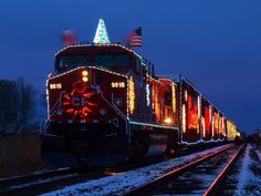 a train with christmas lights on the front