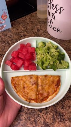 a white plate topped with food on top of a counter next to a bottle of water