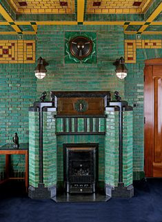 a fireplace in a room with green brick walls