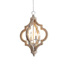 a light fixture with three lights hanging from it's center, and an intricate wooden frame