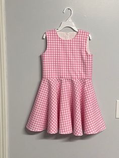 Beautiful  Barbie inspired pink gingham checked twirl dress..  The gingham fabric is Robert Kaufman  cotton.  The sleeveless dress has a fully lined bodice.  The back closes with kam Plastic  snaps.  The dress has a full circle twirl for that little dancer.    I would be happy to make this dress in other colors or fabric.  available in sizes 12 months to size 8  Measurements will be in the photo section Spring Gingham A-line Dress, Cute Sleeveless Plaid Dress, Cute Plaid Sleeveless Dress, Sleeveless Gingham Plaid Dress For Spring, Sleeveless Gingham Plaid Fitted Dress, Spring Picnic Plaid A-line Dress, Spring A-line Gingham Plaid Dress, Spring Gingham A-line Plaid Dress, Spring Gingham Plaid A-line Dress