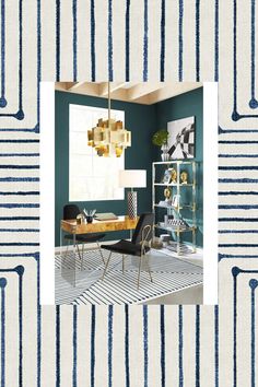 a living room with blue and white striped wallpaper, gold chandelier, black chair, and desk