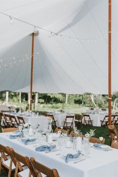 an outdoor tent set up with tables and chairs