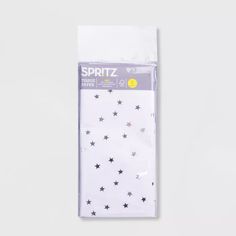 a package of white and black stars on the side of a packaging with yellow dots