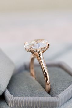 a close up of a ring with a diamond in it on top of a box