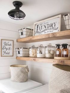 a white washer and dryer sitting next to each other on top of a wooden shelf