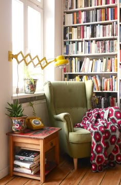 a living room filled with lots of books and furniture