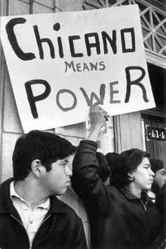 a group of people holding up signs in front of a building that says chicago means power