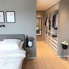 a white bed sitting next to a walk in closet