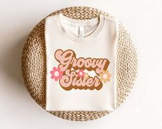 The perfect Groovy Family shirts for your little one's retro birthday party! Customize these shirts for any big announcement or birthday! New baby, promoting to Big Sister and Big Brother, these are the perfect shirts! Choose the CUSTOM option from the drop down to create your own title. Available in Women's, Men's, Kids, Toddler, and infant sizing!*NATURAL ROMPER - standard body bodysuit, runs true to size*NATURAL Youth Tee - crew neck tee, unisex, runs true to size for girls, runs narrow for boys sizing, size up for a more roomy fit*NATURAL Unisex Style- Crew Neck Shirt, fits true to size for men, will run a size big on women Copyright © 2024 by Squishy Cheeks, LLC. All rights reserved. This design or any portion thereof may not be reproduced or used in any manner whatsoever without the Retro Tops With Funny Print As Gift, Retro Birthday Shirt With Graphic Print, Retro Letter Print Tops For Gifts, Retro Letter Print Tops As Gift, Squishy Cheeks, Retro Birthday Party, Retro Birthday Parties, Promoted To Big Sister, Girls Sister