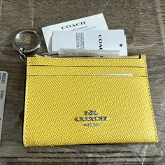 Brand New Mini Skinny Id Case From Coach Retro Yellow, Silver Product Details Signature Coated Canvas And Smooth Leather Two Credit Card Slots Id Window Zip-Top Closure, Fabric Lining Attached Split Key Ring 4 1/4" (L) X 3" (H) X 1/2" (W) Yellow Travel Bags With Card Slots, Yellow Wallet For Everyday Use, Classic Yellow Rectangular Wallet, Retro Yellow, Tag Design, Zip Top, Key Ring, Key Rings, Smooth Leather