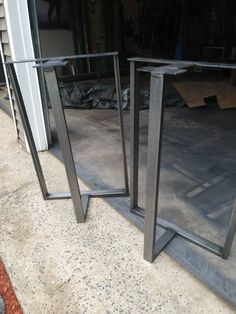 two mirrors sitting on the ground next to each other in front of a building with no doors