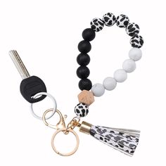 a black and white beaded bracelet with a tassel on the end is shown