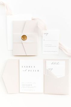 the wedding stationery is laid out on top of each other