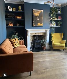 a living room with blue walls and yellow chairs