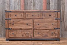 an old wooden dresser sitting on top of a hard wood floor next to a wall