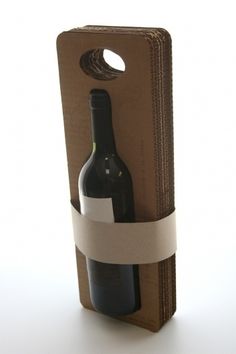 a wine bottle in a cardboard box with a white ribbon around it and two bottles inside