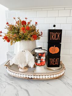 a tray with halloween decorations on it and a trick or treat sign