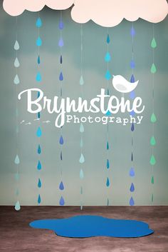 a blue rug sitting on top of a wooden floor next to a wall covered in raindrops