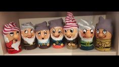 several gnomes are lined up on a shelf