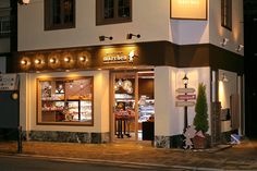 a store front at night with lights on