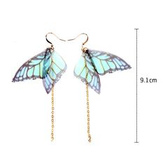 a pair of butterfly earrings with chains hanging from it's ear ends, on a white background