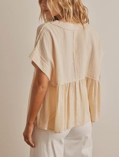 Add a touch of femininity to your wardrobe with our Ruffle Hem Tunic Blouse Top. The delicate ruffle hem adds a playful and romantic touch to any outfit, making you feel confident and stylish. Made with high-quality materials, this top is both comfortable and durable, making it a must-have piece for any fashion-forward woman. The Ruffle Hem Tunic Blouse Top is a perfect delicate top that can also be used as a layering piece. Its ruffle hem adds a feminine and elegant touch, making it ideal for b Feminine V-neck Top With Ruffle Hem, Feminine Ruffle Hem Tops For Day Out, Chic Tops With Ruffle Hem For Spring, Chic Peplum Blouse With Ruffle Hem, Ruffle Sleeve Tops For Summer Layering, Chic Spring Tops With Ruffle Hem, Relaxed Fit Ruffled Blouse For Day Out, Ruffled Blouse With Relaxed Fit For Day Out, Flowy Feminine Beige Tops