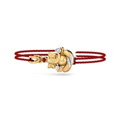 A rakhi (bracelet made of thread, having a solid gold pendant in the center to which the thread is tied) that is made of 18K gold with diamonds. A Ganesha styled real gold rakhi for your brother to make this Raksha Bandhan super special for him. It's not just about the gold rakhi, but the whole package that he receives. The rakhi comes inside a posh gift box that completely elevates the gifting experience for both of you . Satin threads are provided on either side and it comes in a beautiful gif Yellow Gold Bracelet For Festive Gift, Festive Yellow Gold Bracelets For Gifts, Traditional Yellow Gold Bracelet As Gift, Fusion Style Bracelets For Puja And Diwali, 22k Gold Bracelets For Diwali Gift, Temple Jewelry Style Yellow Gold Bracelets As Gift, Temple Jewelry Style Yellow Gold Bracelets For Celebration, Yellow Gold Temple Jewelry Bracelets For Celebration, Yellow Gold Bracelets For Puja And Festive Occasions