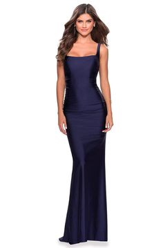 Enter the party and do that walk of a regal beauty in La Femme 28634. This sleeveless beauty features a square neckline, an open back, and back zipper closure. The skirt is styled in a sheath silhouette, ending in a sweep train. Be ready to mesmerize the night in this La Femme creation. Model is wearing Navy color. Style: lafemme_28634 Details: Sleeveless, Jersey, Square Neckline, Open V Back, Ruched Details, Zipper Closure, Sheath Silhouette, Sweep Train, Hollow to Hem Length: Long Neckline: Sq Classy Evening Gowns, Long Jersey Dress, Jersey Prom Dress, Sheath Gown, Trumpet Gown, Prom Dress Stores, Prom Dress Styles, Prom Style, Prom Designs