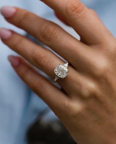 a woman's hand with a diamond ring on it