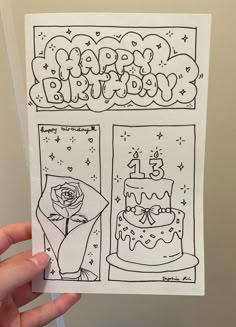 a hand holding up a piece of paper with an image of a birthday cake on it