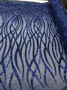 blue sequins are on the back of a bed