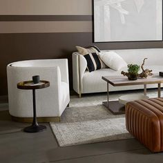 a living room filled with white furniture and brown accents on the walls, along with striped wallpaper