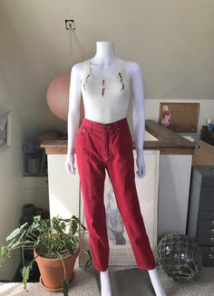 "90's Moschino red cotton peace & love jeans. The jeans have a high waist with a loose, slightly tapered leg. Condition is pre-worn, good. There are light signs of wear (some small, scattered black spots) slight fade, but nothing that stands out. Overall the look is still very good. Made in Italy Labeled size 29 Shown pinned on an XS, 5'10\" tall mannequin Measurements Waist 27 Hips 36 Length 40.5 Inseam 30 Rise 11" 90s Style High Waist Cotton Pants, 90s Style Straight Leg Cotton Pants, Red Full-length Jeans For Spring, Red High-waisted Jeans For Spring, Red High Rise Jeans With Five Pockets, Red High-rise Jeans, Red Cotton Jeans, Retro Red Cotton Bottoms, Retro Red Cotton Jeans