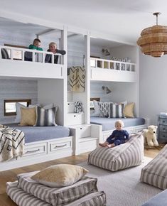 a child sitting on a bean bag chair in a room with bunk beds and other furniture